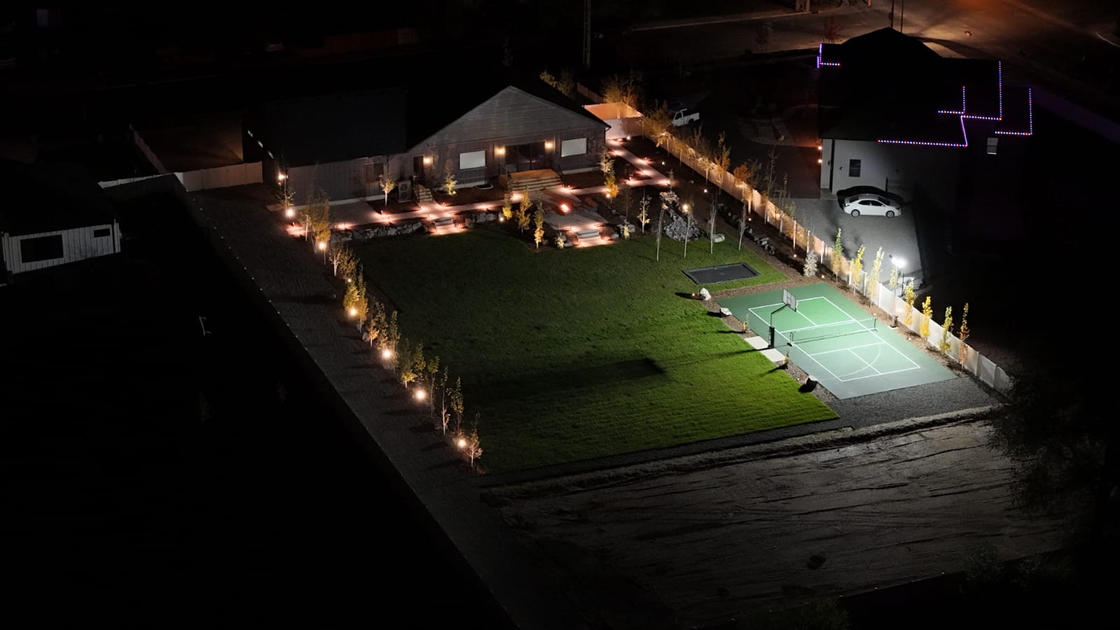 Aerial view of property with landscape lighting