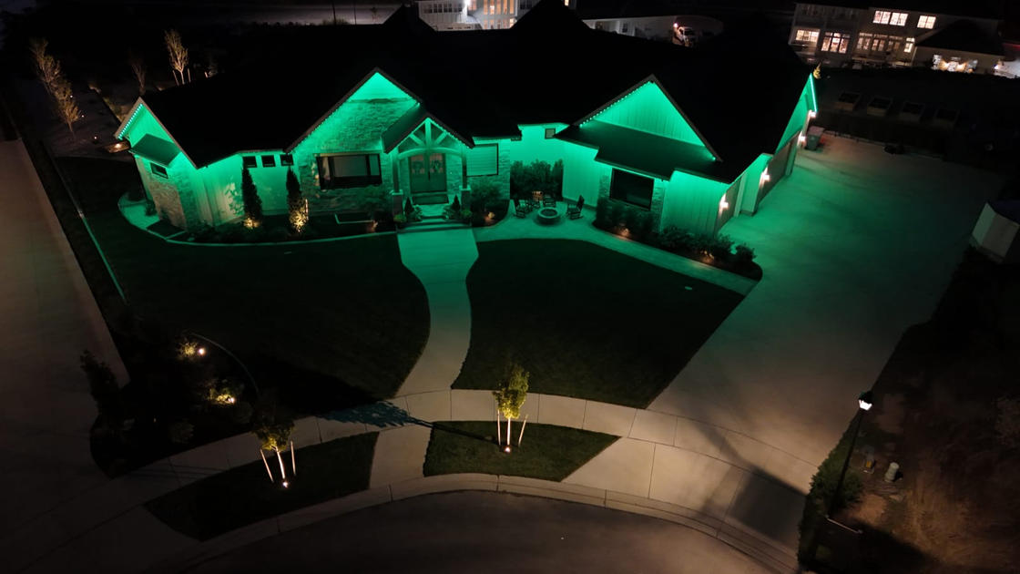 Home exterior with green accent lighting