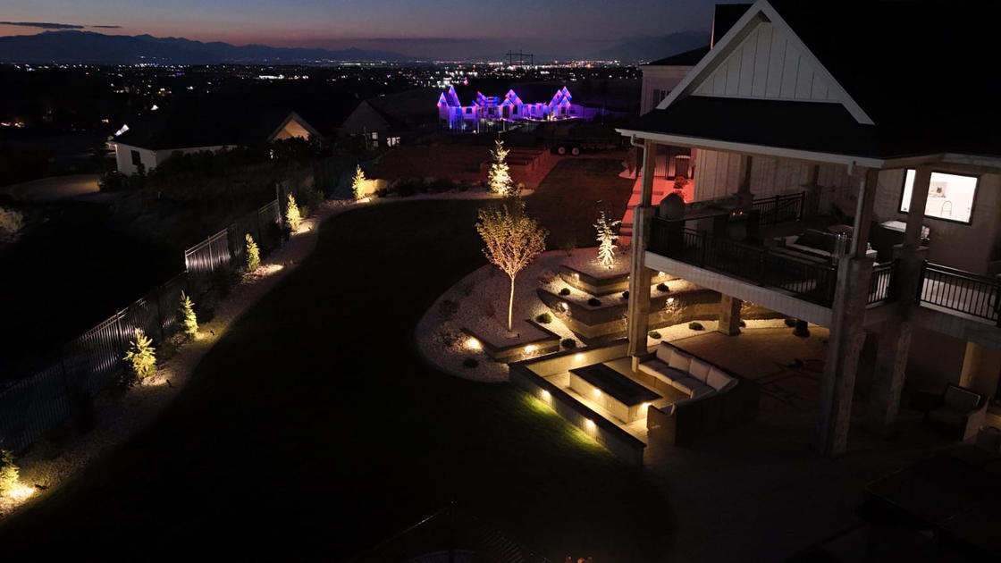 Backyard landscape lighting at dusk