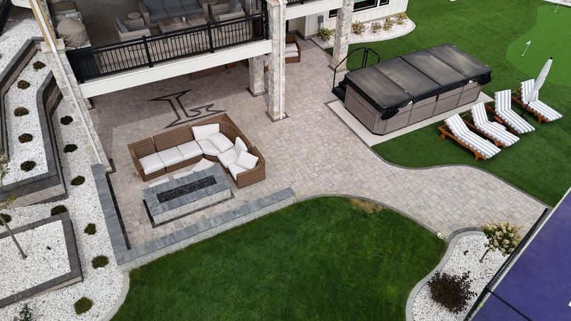 Aerial view of paver patio with fire pit
