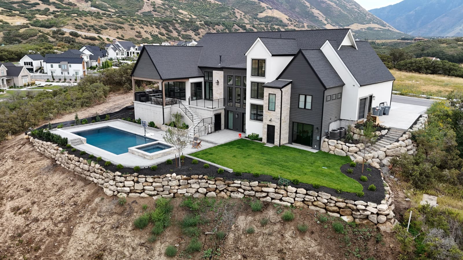 Custom swimming pool with stone retaining wall