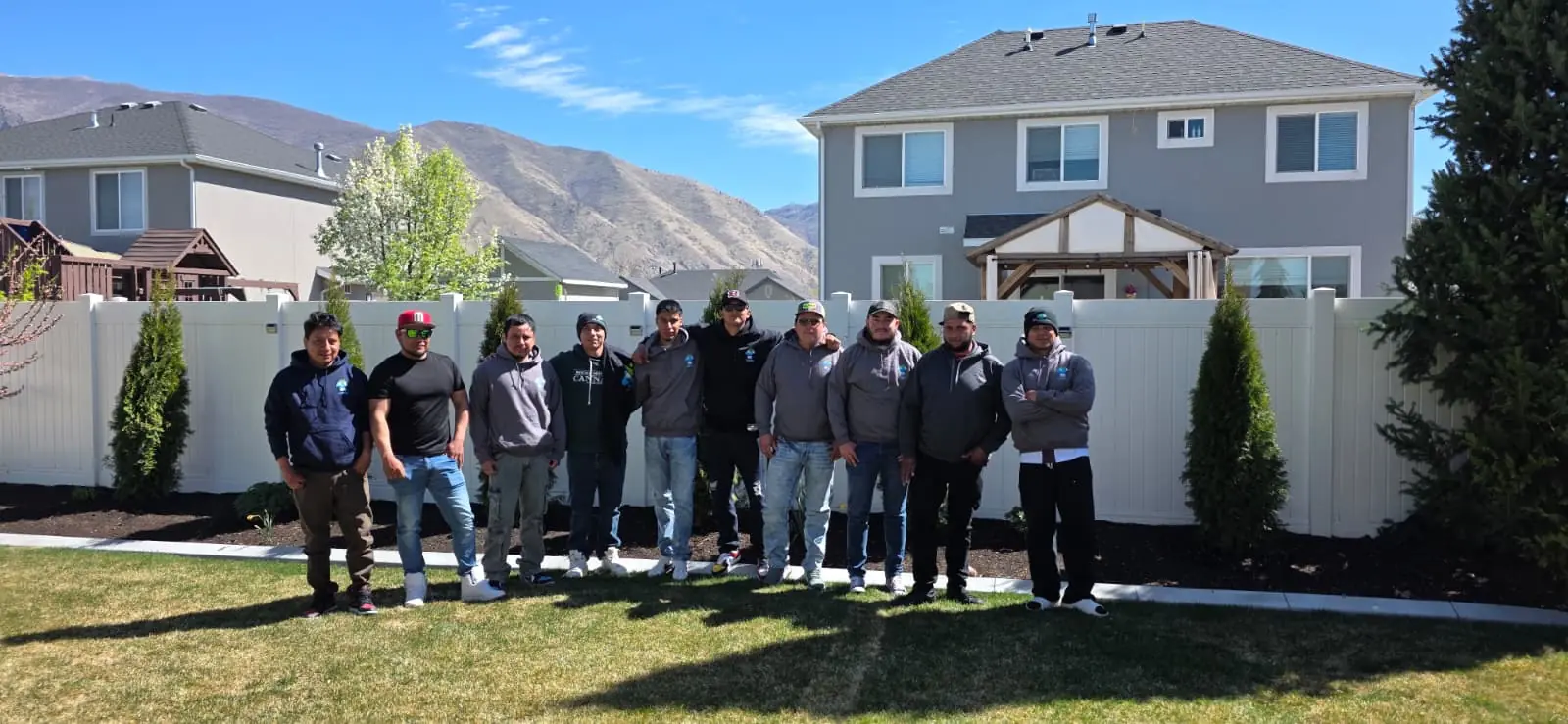 The DK2 Landscaping team standing together in a landscaped yard